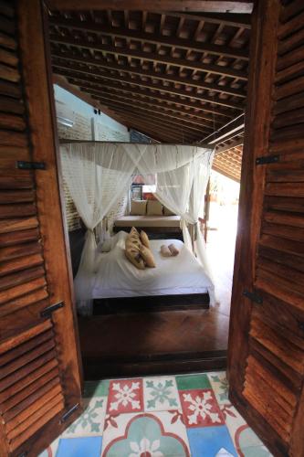 a small bed with two people laying on it at La Cabane in Jimbaran
