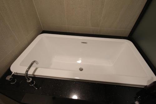 a bath tub in a bathroom with a sink at Hotel Eco stay in Jeonju