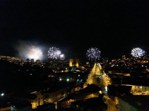 a city with fireworks in the sky at night at Hostal brons in Valparaíso