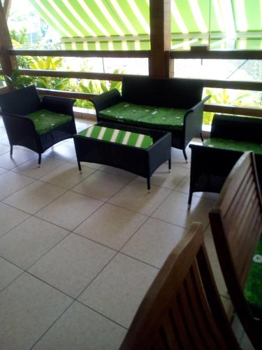 a room with couches and chairs in a building at Très belle location touristique in Sainte-Anne