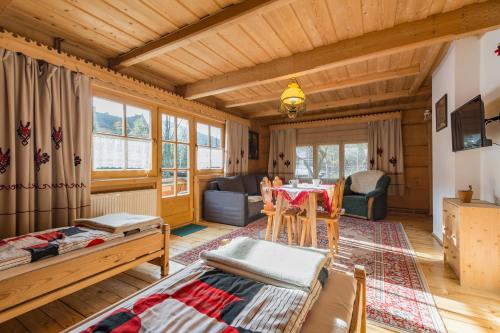 a living room with a table and a dining room at Willa Pod Giewontem in Zakopane