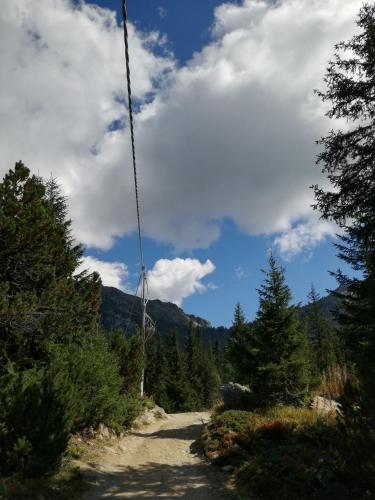 a dirt road with trees and a cloudy sky at Giuly Home in Caspoggio