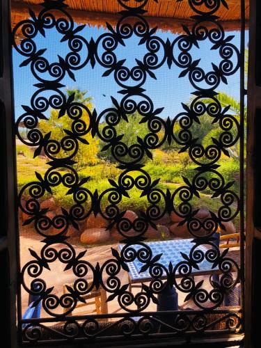 a view of a window with a black iron fence at Les Jardins de Taja in Ourika