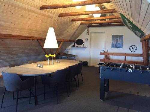 a large room with a large wooden table and chairs at Holmens Guesthouse in Lemming