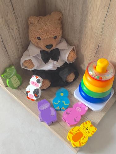 a teddy bear sitting on a shelf with toys at L'ESCALE COTE BLEUE B&B AND Spa in Sausset-les-Pins