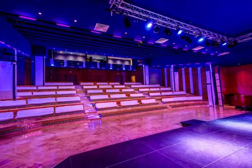 an empty auditorium with rows of chairs and lights at Thabraca Thalasso & Diving in Tabarka