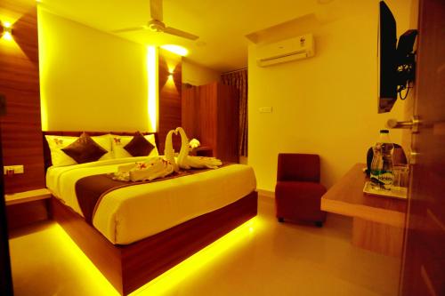 a hotel room with a bed and a chair at HOTEL KEK GRAND PARK in Chennai