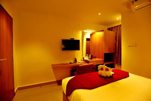 a hotel room with a bed and a desk at HOTEL KEK GRAND PARK in Chennai