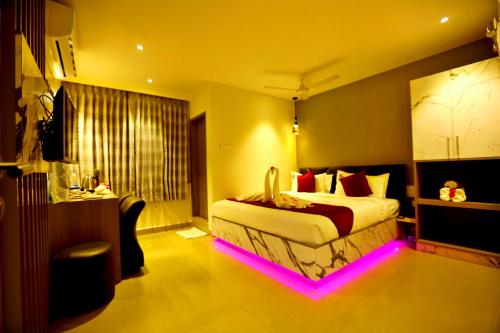 a hotel room with a bed with lights on it at HOTEL KEK GRAND PARK in Chennai
