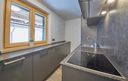 a kitchen with a sink and a window at D-Town Lodge in Saalbach-Hinterglemm