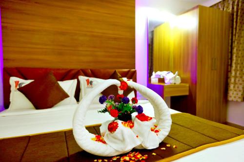 a hotel room with white towels on a bed at HOTEL KEK GRAND PARK in Chennai