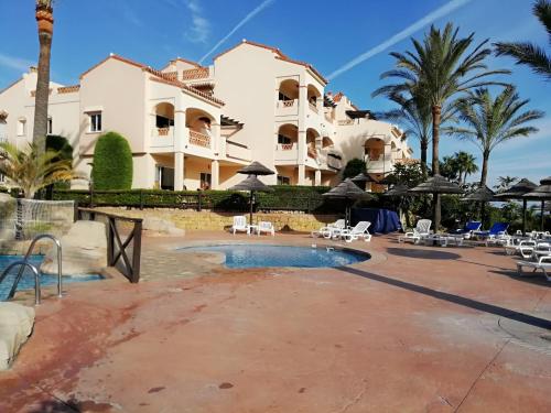 a resort with a swimming pool and palm trees at Club La Costa World Resort in Fuengirola
