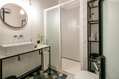 a white bathroom with a sink and a shower at Porto Insight Apartments- with balcony in Porto