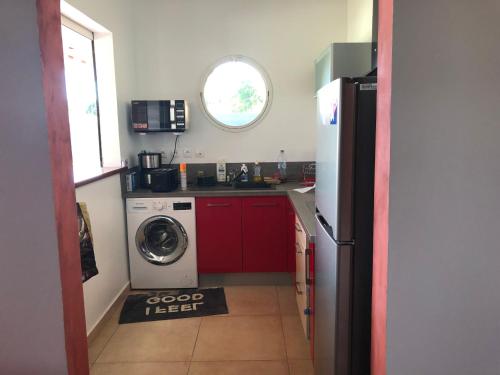 a kitchen with a refrigerator and a washing machine at Gîte étoile du matin Grand-bourg de Marie-galante in Grand-Bourg