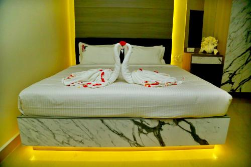 a bed with two towels on top of it at HOTEL KEK GRAND PARK in Chennai