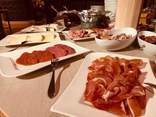 a table with several plates of food on it at Rabenauer Mühle "bed & breakfast" in Rabenau