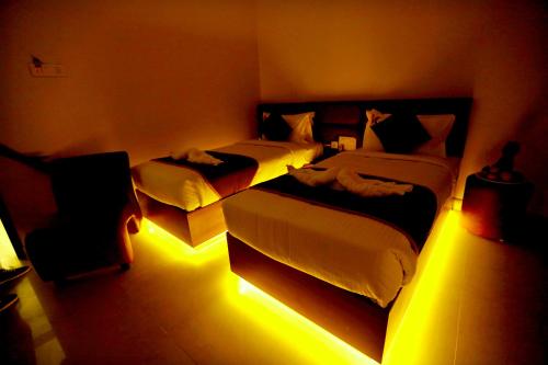 a bedroom with two beds with lights in it at HOTEL KEK GRAND PARK in Chennai