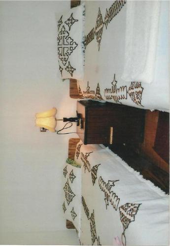 a bedroom with a bed with black and white pillows at Selam Guest House in Lalibela