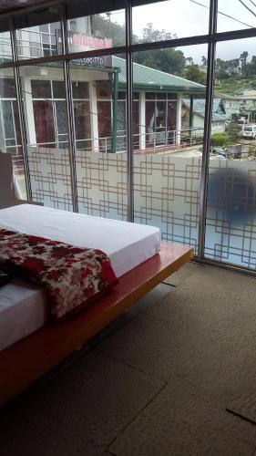 a bedroom with a bed in front of a building at Udeni inn in Nuwara Eliya