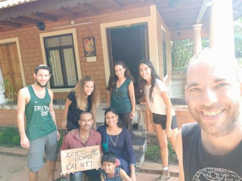a group of people standing in front of a house at The Munroe Vibes Inn in Munroe Island