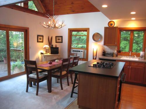 a kitchen with a table and chairs and a dining room at The Catskill Cabin in Elka Park