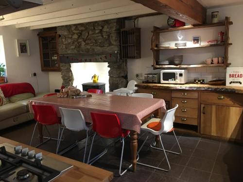 a kitchen with a table and chairs in a room at No21 Hop to Zipworld in Bethesda