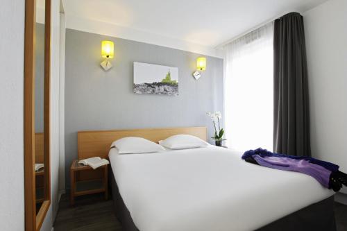Katil atau katil-katil dalam bilik di Aparthotel Adagio Access Marseille Prado Périer