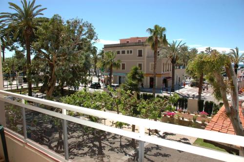 a balcony with palm trees and a building at Hotel Planas in Salou