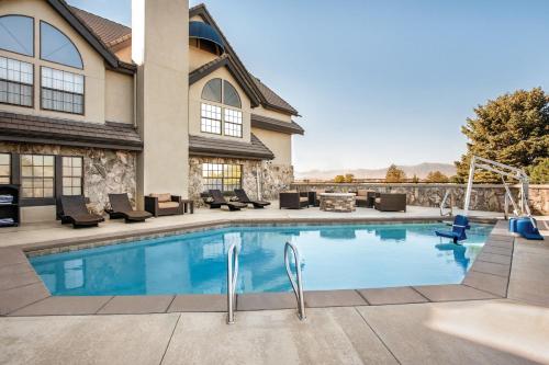 a swimming pool in front of a house at Radisson Hotel Salt Lake City Airport in Salt Lake City