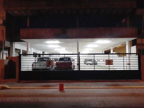 two cars are parked in a car garage at Victor Hotel in Villa Carlos Paz