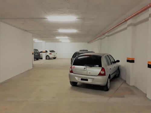 a parking garage with a car parked in it at Victor Hotel in Villa Carlos Paz