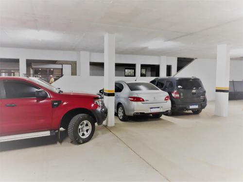 a parking garage with three cars parked in it at Victor Hotel in Villa Carlos Paz