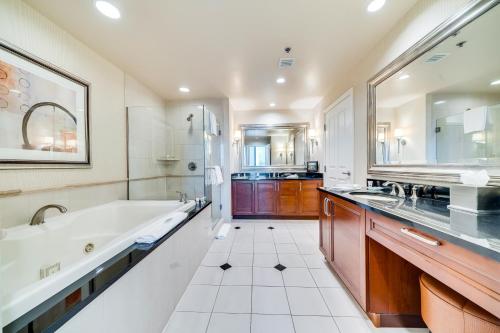 a large bathroom with a tub and a sink at Jet Luxury at The Signature Condo Hotel in Las Vegas