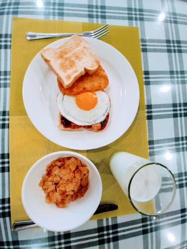 two plates of food with eggs and toast on a table at The Red House in Sokcho
