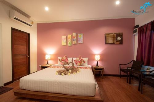 a bedroom with a bed with a stuffed animal on it at Aukotan Place in Koh Tao