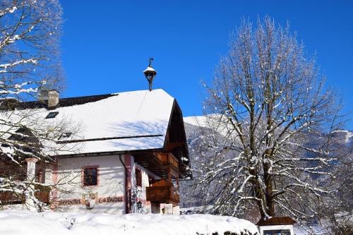 a snow covered house with a light on the roof at Seehotel Huber in Sankt Gilgen