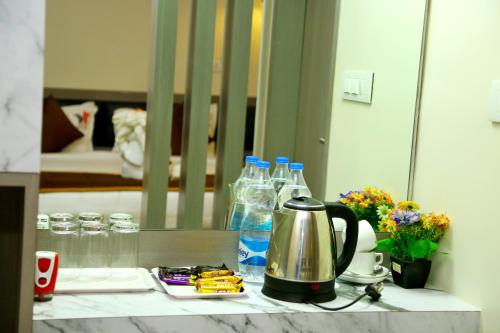 a counter with bottles of water and a tea kettle at HOTEL KEK GRAND PARK in Chennai