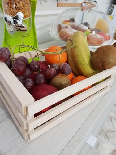 a wooden crate of fruit on a table at Perla Sicula in Catania