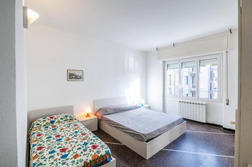 a small bedroom with a bed and a window at Finalmarina Centro 2 in Finale Ligure