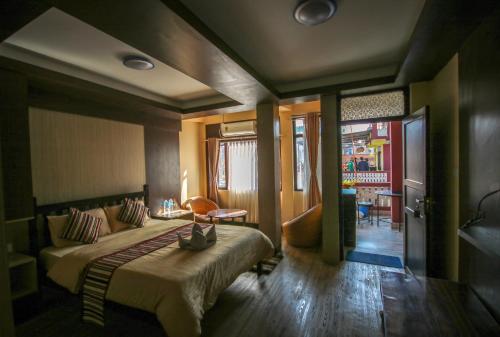 a bedroom with a bed and a living room at Peace Home in Kathmandu