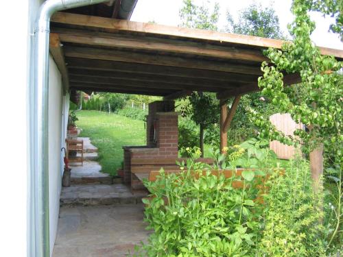 a wooden pergola with a staircase in a garden at Beim Schachnerhaus in Pöllauberg