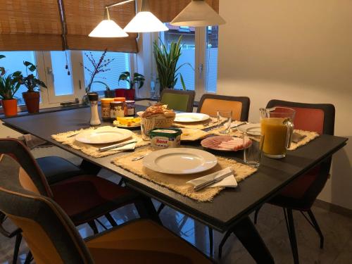 a dining room table with food and drinks on it at Floriande Stay in Hoofddorp