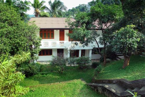 a white house with trees in front of it at 12 B Lewella Road, Kandy. in Kandy