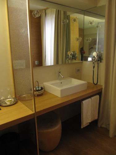 a bathroom with a sink and a large mirror at Mario's Garni in Pescocostanzo