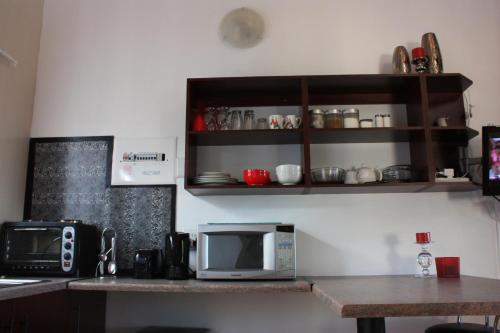 a kitchen with a counter with a microwave and a table at Knock Out View Clarens in Clarens