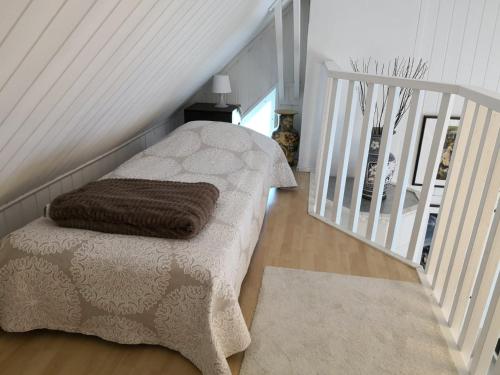 a room with a bed with a blanket and a rug at Lovely Mint Garden Studio in Vantaa