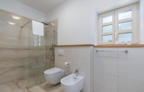 a bathroom with a toilet and a glass shower at Design and Luxury Villa with Pool in Kukci