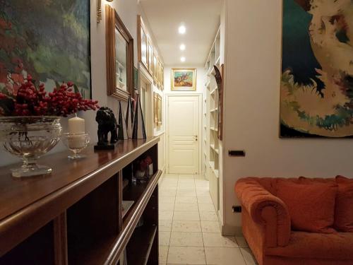 a hallway with a couch and a table with a vase at Suite Ottocento napoletano in Naples