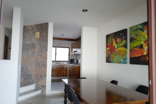 a kitchen and dining room with a table in a house at Villas La Ceiba in Playa del Carmen