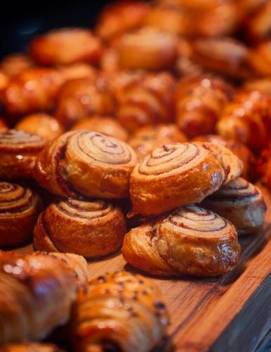 a bunch of pastries on a wooden table at Hotel Lake House Kinneret in Tiberias